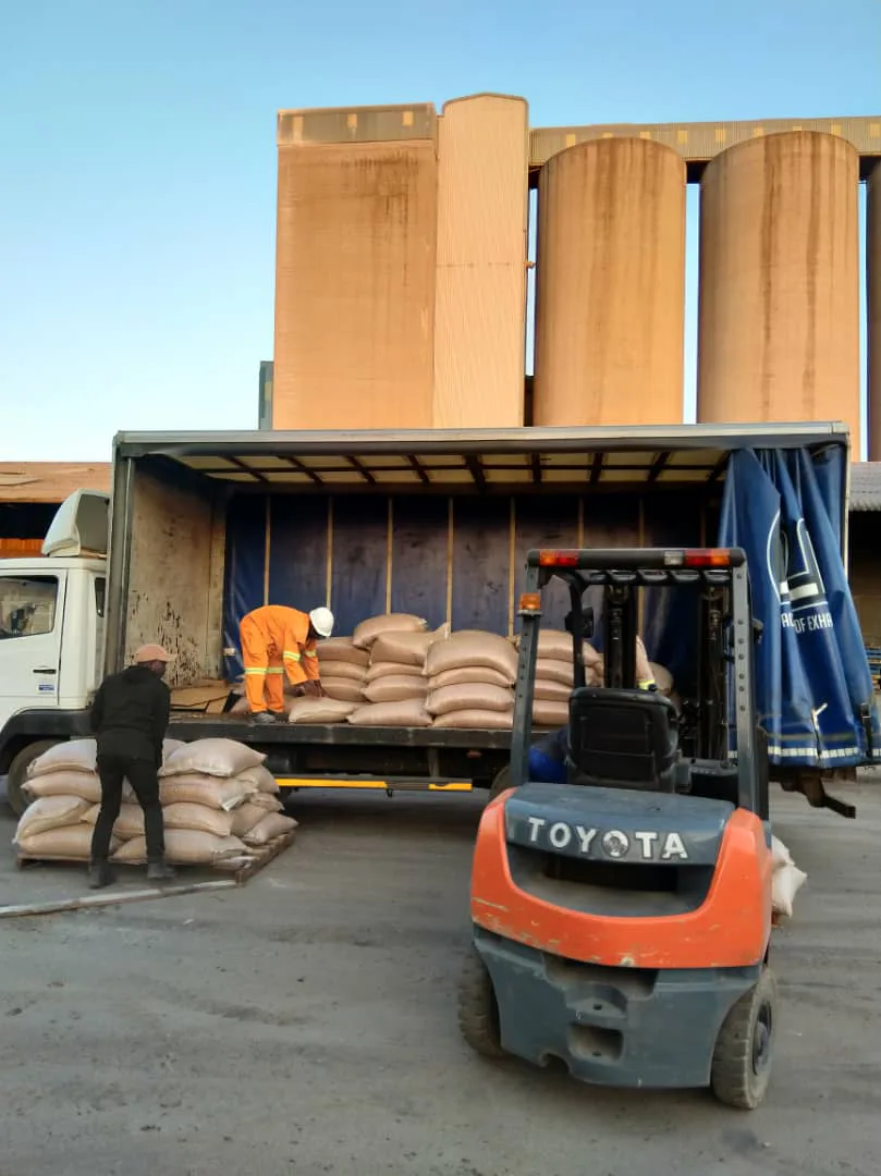 Forklift loading bagged commodity into a truck at a Zimbabwean depot — AYCAS trade operations